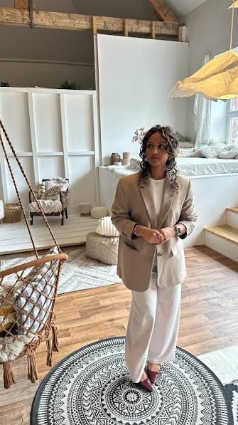 Roshani Thanapalasingham in beigem Blazer in einem hellen Raum